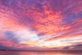 Stunning red and purple and yellow sunset reflecting on the ocean