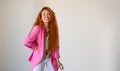 Portrait of happy ginger young woman on white background with large copy space