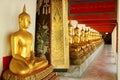 Row of Buddha Images in Sitting Posture at the Cloister of Wat Pho or Temple of the Reclining Buddha, Bangkok, Thailand Royalty Free Stock Photo