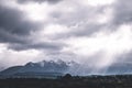 Stunning scene landscape during a cloudy day with sun ray through the cloud over the snow mountain. Dramatic photo style. I