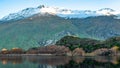 Stunning of the scenery of rocky snow mountain with the reflection of the yellow leafs tree forest in Autumn. Diamond lake track Royalty Free Stock Photo