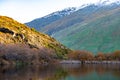 Stunning of the scenery of rocky snow mountain with the reflection of the yellow leafs tree forest in Autumn. Diamond lake track Royalty Free Stock Photo