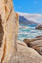 Stunning seaside location for a summer holiday in Cape Town. Boulders at a beach with ocean waves and water washing over