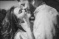 Stunning sensual outdoorblack and white portrait of young stylish fashion couple in love. Woman and man embrace and want to kiss. Royalty Free Stock Photo