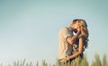 Stunning sensual young couple in love embracing at the sunset in