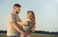 stunning sensual young couple in love posing at the sunset in summer field Royalty Free Stock Photo