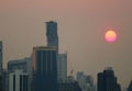 Stunning setting sun amongst the skyscrapers in Bangkok urban, Thailand