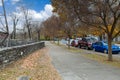 A stunning shot of an autumn landscape on the street with fallen autumn leaves on the ground and gorgeous autumn trees Royalty Free Stock Photo