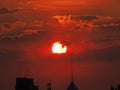 Stunning shot of a beautiful red sunset illuminating the skyline of an urban metropolis Royalty Free Stock Photo