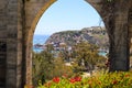 A stunning shot of the boats and the yachts in the Dana Point Harbor through one of the stone arches on the hillside above Royalty Free Stock Photo