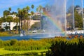 Stunning shot of the deep blue lake water, the lush green plants in the middle of the lake, palm trees and people on the water Royalty Free Stock Photo