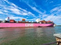 A stunning shot of a large pink container ship sailing down the Savannah River with vast blue river water