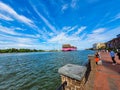 A stunning shot of a large pink container ship sailing down the Savannah River with vast blue river water