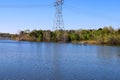 A stunning shot of lush green and autumn colored trees and plants on the bank of the lake with still vast blue lake waters Royalty Free Stock Photo