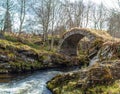 a beautiful scene of some stone bridge over the stream running below