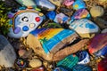 A stunning shot of a rock memorial along a bike path at the beach with colorful rocks and lush green trees