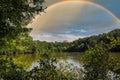 A stunning shot of the silky green lake water of Candler Lake surrounded by lush green trees on the banks of the lake