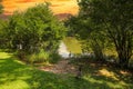 A stunning shot of the silky green lake water of Candler Lake surrounded by lush green trees on the banks of the lake