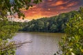 A stunning shot of the silky green lake water of Candler Lake surrounded by lush green trees on the banks of the lake