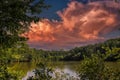 A stunning shot of the silky green lake water of Candler Lake surrounded by lush green trees on the banks of the lake