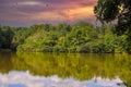 A stunning shot of the silky green lake water of Candler Lake surrounded by lush green trees on the banks of the lake