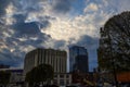 A stunning shot of the skyscrapers and office buildings in the cityscape with powerful clouds at sunset in downtown Nashville