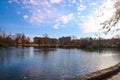 A stunning shot of the still blue lake water surrounded by gorgeous autumn trees in the park with a view of The Parthenon