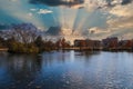 A stunning shot of the still blue lake water surrounded by gorgeous autumn trees in the park with a view of The Parthenon