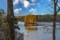 A stunning shot of the still blue waters of the lake at Stone Mountain park with lush green and autumn colored trees reflecting of