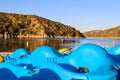 A stunning shot of the still lake waters with majestic mountain ranges reflecting off the water with blue sky