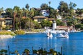 Stunning shot of the waterfall, deep blue lake water, the lush green plants in the, palm trees and people on the water Royalty Free Stock Photo