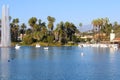 Stunning shot of the waterfall, deep blue lake water, the lush green plants in the, palm trees and people on the water Royalty Free Stock Photo