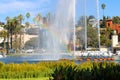 Stunning shot of the waterfall, deep blue lake water, the lush green plants in the, palm trees and people on the water Royalty Free Stock Photo