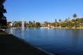 Stunning shot of the waterfall, deep blue lake water, the lush green plants in the, palm trees and people on the water Royalty Free Stock Photo