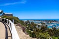 A stunning shot of the white boats and yacht docked and sailing Dana Point Harbor with deep blue ocean water, lush green plants Royalty Free Stock Photo