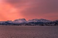 Stunning sight of snow-capped mountains silhouetted against a pink sky