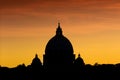 Stunning silhouette view of the dome of basilica San Pietro in Rome at red sunset, backlight