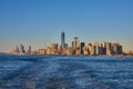 Stunning southern Manhattan island from ferry with soft golden light