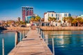 Stunning spring cityscape of Vlore port with old wooden pier. Calm morning seascape of Adriatic sea.