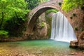 Stunning spring landscape.Paleokarya, old stone arched bridge, between two waterfalls.