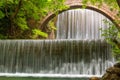 Stunning spring landscape.Paleokarya, old stone arched bridge, between two waterfalls.