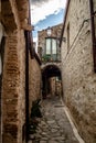 Rocca Imperiale: Italian Street with Old Houses, Stone Floors, and the street continues to a gate under the house