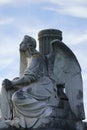 Sitting stone angel statue on historic cemetery Royalty Free Stock Photo