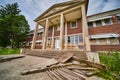 Stunning stone and brick entrance of abandoned building with broken wood and overgrown fields Royalty Free Stock Photo