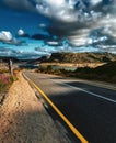 Stunning vivid road landscape with view into distance. Blue sky with clouds