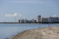 a stunning summer landscape at Crandon Park with blue ocean water, green palm trees and grass, people walking, hotels and condos