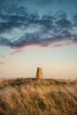 Stunning Summer sunset landscape image of trig point in South Downs National Park in English countryisde Royalty Free Stock Photo