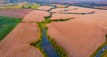 Stunning summer view from flying drone of the river in the shape of tree among the field of wheat Royalty Free Stock Photo