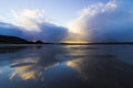 Stunning sundown storm cloud reflection off the water pooled surface of Red Wharf Bay, Anglesey