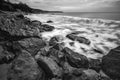 Stunning sunrise over the sea with the rocky sea coast in black and white Royalty Free Stock Photo